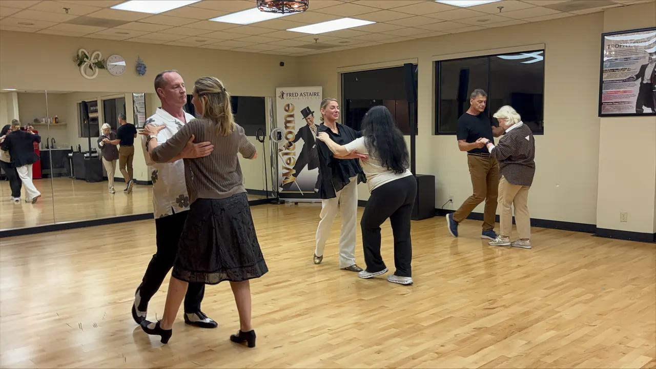 Adults practicing ballroom dance in the Solana Beach studio.
